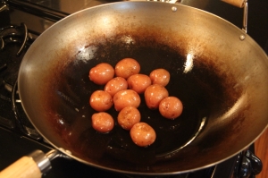 The potatoes are sizzling peanut oil, making the skins crispy.