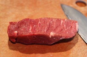 A strip of beef tenderloin, before grilling